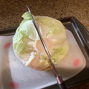 Cut cabbage in half through stem